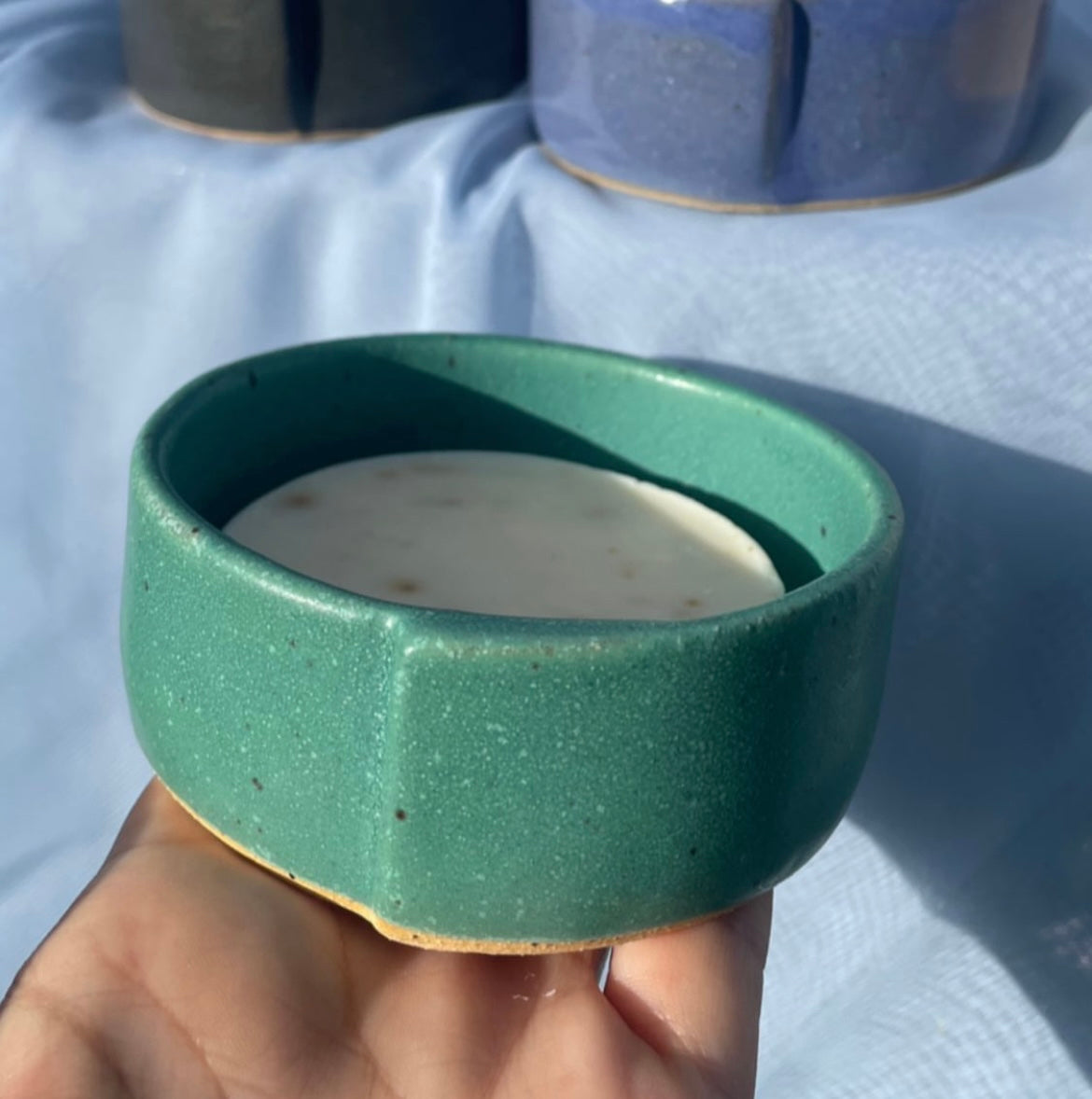 solid dish soap bar in green ceramic ramekin